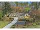 Well-maintained home with a landscaped front yard and a long driveway in a wooded setting at 7265 Hunters Branch Dr, Sandy Springs, GA 30328