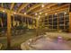 Enjoy the evening in a backyard hot tub surrounded by wooden beams and a stone retaining wall at 7265 Hunters Branch Dr, Sandy Springs, GA 30328