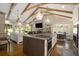 Eat-in kitchen with breakfast nook and exposed beams overlooking living area at 7265 Hunters Branch Dr, Sandy Springs, GA 30328