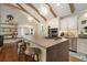 Bright kitchen with exposed beams, pendant lighting, stainless appliances, and breakfast nook at 7265 Hunters Branch Dr, Sandy Springs, GA 30328