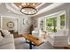 Inviting living room with hardwood floors, comfortable seating, and views of the outdoors at 7265 Hunters Branch Dr, Sandy Springs, GA 30328