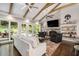Bright living room with vaulted ceiling, exposed beams, and sliding doors to outdoor patio at 7265 Hunters Branch Dr, Sandy Springs, GA 30328