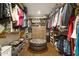 Spacious walk-in closet with custom shelving, drawers, and an ottoman for added convenience at 7265 Hunters Branch Dr, Sandy Springs, GA 30328