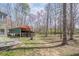 Open backyard features a storage shed and beautiful green space with mature trees at 1765 Dew Pl, Marietta, GA 30064