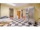 Basement featuring checkerboard tile and stainless steel refrigerator at 1765 Dew Pl, Marietta, GA 30064