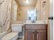 Neutral bathroom with a patterned shower curtain, ceramic tile, and dark wood vanity at 1765 Dew Pl, Marietta, GA 30064