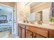 Bathroom with double sinks, a tiled floor, and a view into a bedroom, creating an open and inviting space at 1765 Dew Pl, Marietta, GA 30064