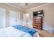 Bedroom featuring wood floors, a dresser with a TV, and neutral wall paint, offering a relaxing ambiance at 1765 Dew Pl, Marietta, GA 30064