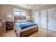 Well-lit bedroom featuring a wooden bed frame with blue accents and a large window providing natural light at 1765 Dew Pl, Marietta, GA 30064