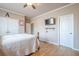 Bedroom with wooden floors, a mounted TV, and a spacious closet, offering both style and functionality at 1765 Dew Pl, Marietta, GA 30064