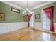 Classic dining room with green walls, white trim, beautiful wood floor, and bright windows at 1765 Dew Pl, Marietta, GA 30064