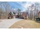 Charming home with brick and siding exterior, mature trees, and a spacious driveway at 1765 Dew Pl, Marietta, GA 30064