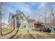 View of the back of the two-story home, green siding, brick foundation, and large windows at 1765 Dew Pl, Marietta, GA 30064