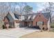 Beautiful exterior of a home with brick, siding, well-maintained landscaping, and attached garage at 1765 Dew Pl, Marietta, GA 30064