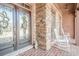 Inviting front porch with stone accents, rocking chairs, and decorative glass front door at 1765 Dew Pl, Marietta, GA 30064