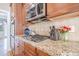 A kitchen features granite countertops, stainless steel appliances and wood cabinets at 1765 Dew Pl, Marietta, GA 30064