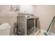 Laundry room with a washer, dryer, sink and white cabinets above appliances at 1765 Dew Pl, Marietta, GA 30064