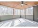 Covered sunroom featuring tile flooring and screened-in windows providing backyard views at 1765 Dew Pl, Marietta, GA 30064