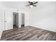 Bright bedroom featuring wood-look floors, ceiling fan, and closet doors at 3232 Abbeywood Dr, Decatur, GA 30034