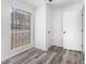 Clean bedroom with updated floors, a closet, and large window with blinds at 3232 Abbeywood Dr, Decatur, GA 30034