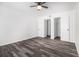 Bright bedroom featuring wood-look floors, ceiling fan, and closet doors at 3232 Abbeywood Dr, Decatur, GA 30034