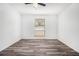 Bright bedroom with modern floors, fresh white paint, ceiling fan and large window at 3232 Abbeywood Dr, Decatur, GA 30034