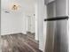 Close-up of stainless steel refrigerator near white kitchen cabinets and dining area at 3232 Abbeywood Dr, Decatur, GA 30034