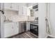 Modern kitchen with stainless appliances, white cabinets, and unique backsplash at 3232 Abbeywood Dr, Decatur, GA 30034