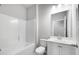 Bathroom features white fixtures, a bath and shower combination, and neutral walls at 113 Canal St, Hampton, GA 30228