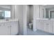 Modern bathroom featuring double sink vanity with white cabinets and tiled floors at 113 Canal St, Hampton, GA 30228