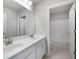 Spacious bathroom featuring double sinks, white cabinets, and a view of the bath and shower at 113 Canal St, Hampton, GA 30228