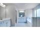 Bright bathroom features double vanity, soaking tub, and separate tiled shower at 113 Canal St, Hampton, GA 30228