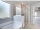 Spacious bathroom featuring a glass-enclosed shower and a separate soaking tub at 113 Canal St, Hampton, GA 30228