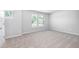 Bright bedroom with large windows allowing ample natural light and neutral carpet at 113 Canal St, Hampton, GA 30228
