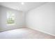 Bright bedroom featuring a window, plush carpet, and neutral-toned walls at 113 Canal St, Hampton, GA 30228