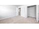 Bedroom featuring neutral carpet and spacious closet with bi-fold doors at 113 Canal St, Hampton, GA 30228