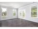 Open dining area features hardwood floors, modern lighting, and large windows overlooking the outdoor scenery at 113 Canal St, Hampton, GA 30228