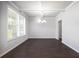 Bright dining room featuring dark wood floors and ample natural light at 113 Canal St, Hampton, GA 30228