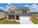 Beautiful brick home with a two car garage and well manicured front yard at 113 Canal St, Hampton, GA 30228