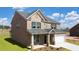 Beautiful two-story brick home with a well-maintained lawn and attached garage at 113 Canal St, Hampton, GA 30228