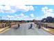 View of the community entrance featuring an automated gate, stone pillars and beautiful landscaping at 113 Canal St, Hampton, GA 30228