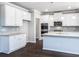 Modern kitchen features white cabinets, granite countertops, stainless steel appliances, and hardwood floors at 113 Canal St, Hampton, GA 30228