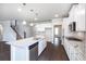 Modern kitchen with white cabinets, stainless steel appliances, and granite countertops at 113 Canal St, Hampton, GA 30228