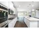 Spacious kitchen with stainless steel appliances, granite countertops, and open to the living area at 113 Canal St, Hampton, GA 30228