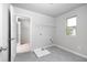 Well-lit laundry room including utility sink, window, tile floor, and coated wire shelves at 113 Canal St, Hampton, GA 30228