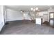Open concept living room with a fireplace, stairs, kitchen and lots of natural light at 113 Canal St, Hampton, GA 30228