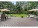 Spacious wooden deck with patio seating, dining set, and grill overlooks the lush green backyard at 2109 Allgood Rd, Marietta, GA 30062