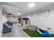 Bright basement play area with turf, picnic table, playhouse, and decorative wall art creates a fun space at 2109 Allgood Rd, Marietta, GA 30062
