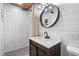 Stylish bathroom with subway tile shower, a round mirror, and a wood vanity at 2109 Allgood Rd, Marietta, GA 30062