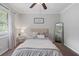 Serene bedroom with ample light from the window and furnished with a dark wood dresser at 2109 Allgood Rd, Marietta, GA 30062